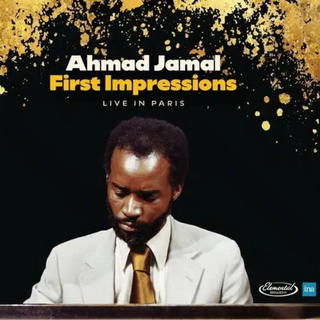 Album cover for Ahmad Jamal's 'First Impressions Live in Paris', featuring a portrait of the pianist in a white suit and gold tie against a black background with gold paint splatters and yellow title text.