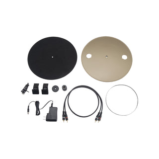 Set of electronic components including two circular plates, cables, and a power adapter on a white background.