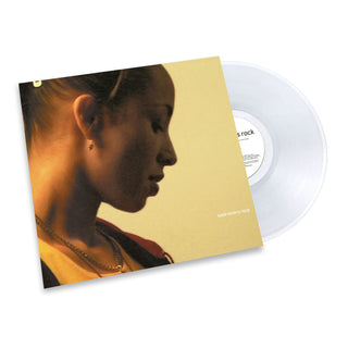 A vinyl record album shown with its sleeve partially covering the disc. The sleeve features a warm-toned portrait of a woman in profile against a pale yellow background, and the record itself is translucent white.